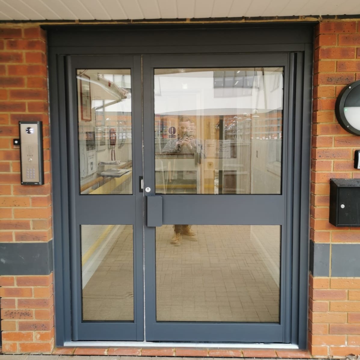 An aluminium door with a lock.